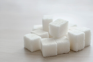 close up of sugar cubes On a light neutral background. Place for text, copyspace.