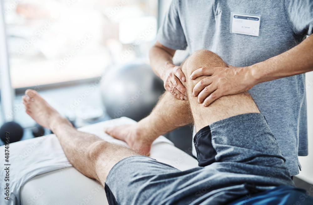 Poster well sort out these sprains and strains. closeup shot of an unrecognizable physiotherapist treating 