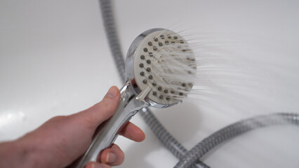 Shower head in bathroom with water drops flowing. Clean water concept. Shower funnel. Shower faucet...