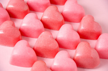 Obraz na płótnie Canvas Chocolate bonbons in the shape of pink hearts.