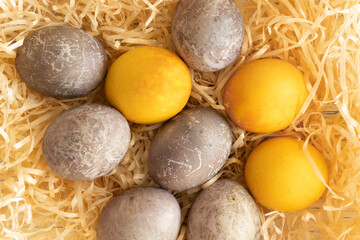 Easter eggs on straw. Religious spring holidays.