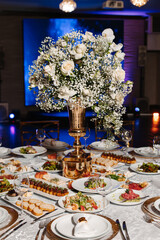 exposition of flowers in a vase on a decorated table