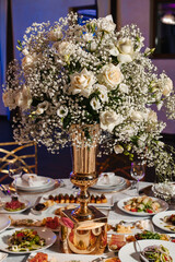 exposition of flowers in a vase on a decorated table