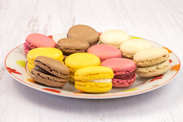 several macaroon in a plate on a white background