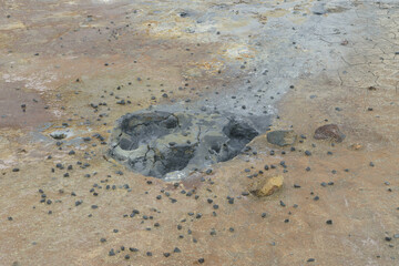 vulcanic mud hole with sulphur evaporating from the ground