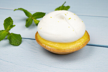 lemon meringue pie isolated on a white background with fresh mint