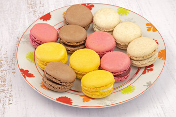 several macaroon in a plate on a white background