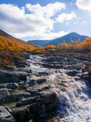 Beautiful mountain waterfall among rocks in polar summer in Khibiny Mountains. Kola Peninsula, Arctic, polar summer