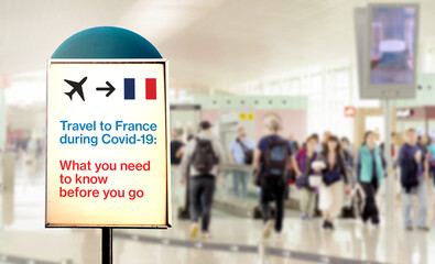 a signal inside an airport that warns about what to know before flying to France during the...