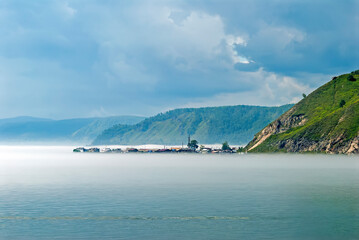 Peninsula on the lake shrouded in fog