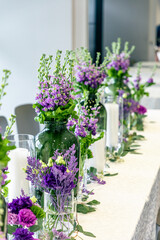 Purple and violet wedding flower arrangements, made out of carnations lisianthus and matthiola flowers. 