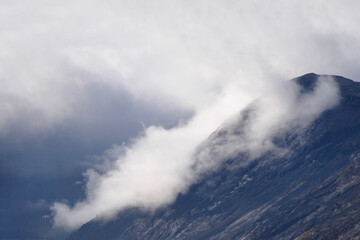 The clouds caught on the tops of the mountains. Low clouds in the mountains. Khibiny, Russia.
