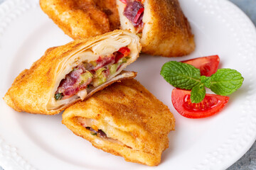 Turkish Pacanga Boregi with pastirma (pastrami) and cheddar (melted) cheese. - Pastirmali Borek