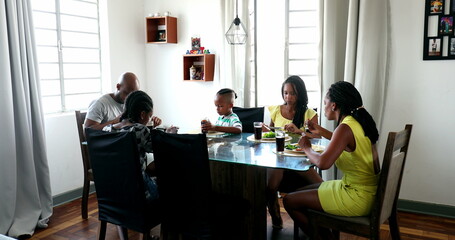 Black African family eating lunch together