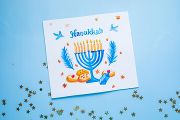 Hanukkah symbols flat lay.  Traditional jewish holiday greeting card design with happy hanukkah congratulations. Menorah with david star, pitta bread
