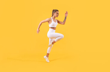 Fototapeta na wymiar active fitness girl runner running on yellow background