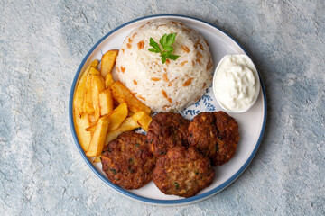 Traditional Turkish food; dry meatballs or inegöl meatballs with potatoes and rice pilav(Turkish name; Kuru kofte)