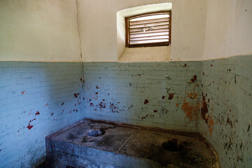 An old outdoor toilet building with a hole in the floor in a third world country. Background with...