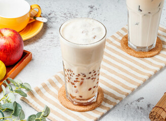 Pearl milk tea Boba / Bubble tea in glass jar on mat with grey background breakfast drink