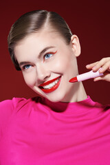 Obraz premium girl applying lipstick