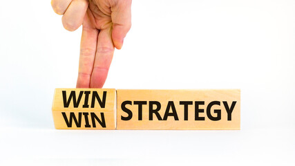 Win-win strategy symbol. Businessman turns wooden cubes with words win win strategy. Beautiful...