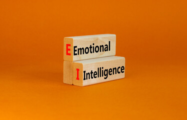 EI emotional intelligence symbol. Concept words EI emotional intelligence on wooden blocks on a beautiful orange table orange background. Business EI emotional intelligence concept, copy space.