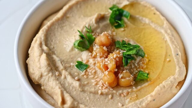 hummus with sesame and olive oil close up. Healthy vegan food. Hummus rotation. Vegetarien dish. Mezze chickpeas. Kosher food