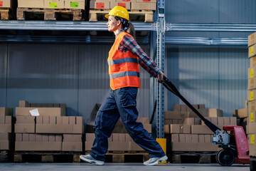 A female warehouse employee driving forklift.