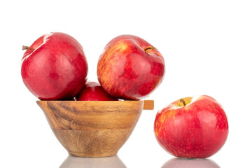 Several ripe red apples with wood cup, macro, isolated on white background.

