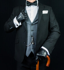 Portrait of Gentleman in Dark Suit and Leather Gloves Holding Umbrella. Vintage Style and Retro...
