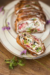 Homemade pancake roll with cottage cheese cream, strawberry and pancake roll on wooden table