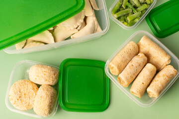 Frozen semi-finished products in containers on a green background