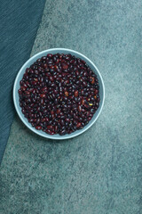 black beans in a large ceramic bowl on a dark marble surface