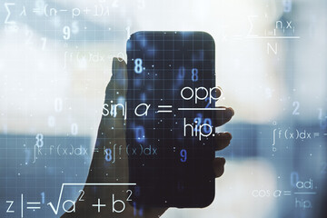 Double exposure of creative scientific formula concept and hand with cell phone on background,...