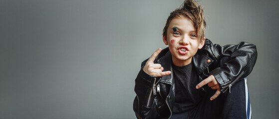 an emotional cheerful boy in a black rocker leather jacket, with a mohawk on his head, with a...