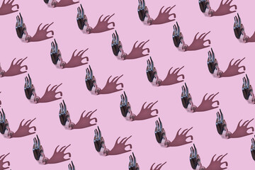 iron Hand-shaped jewelry holder, pattern made from iron Hand Ring Holder, , on trendy pink background. Flat lay, top view. OK hand shape ring display holder for jewelry display