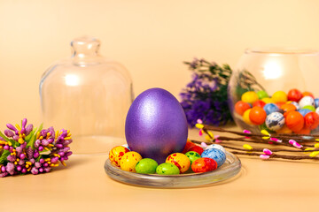 Easter composition on a beige background. Colorful eggs closeup with copy space. Postcard or invitation template.