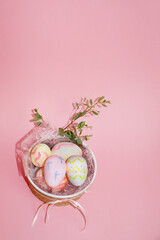 Fototapeta na wymiar easter eggs in a decorated plate on a pink background copy space