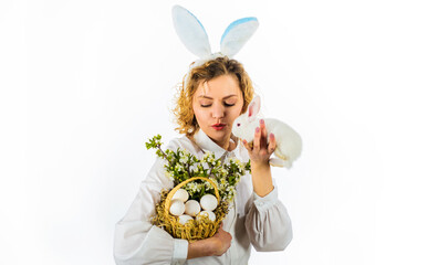 Happy Easter day. Girl in bunny ears with basket eggs and small rabbit. Religion symbol. Spring holiday.
