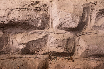 Masonry texture. The rough surface of the stones is plastered and painted.