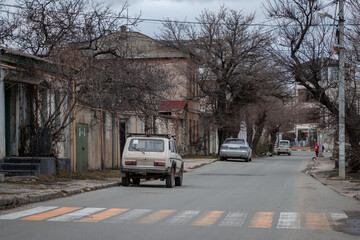 View of the street in the old town. Cars are parked near sidewalks and houses. City of Sevastopol, Republic of Crimea.