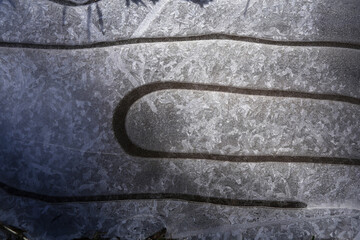 Interesting structure of the surface of a frozen puddle on a cold sunny morning.