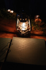 Fototapeta na wymiar burning candles on a dark night in a wooden lantern