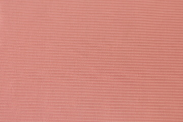 background or texture of coral colored fabric with striped pattern on its fabric
