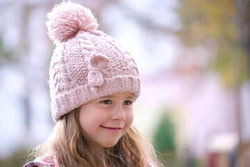 Portrait of cute little child girl in pink hat