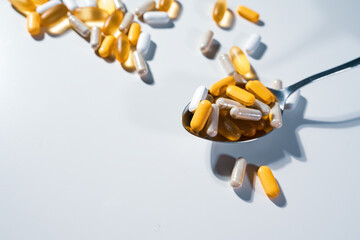Big pharma conspiracy theory. Medical pills lying on spoone. Pharmacy and healthcare are very...