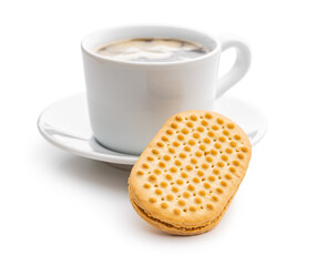 Sweet sandvich cookies and coffee cup. Biscuits with cocoa cream filling isolated on white background.