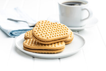 Sweet sandvich cookies. Biscuits with cocoa cream filling on plate.