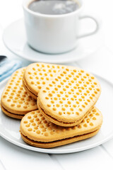 Sweet sandvich cookies. Biscuits with cocoa cream filling on plate.