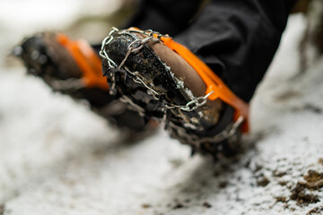 Close up of snow shoes and shoe spikes in winter. 